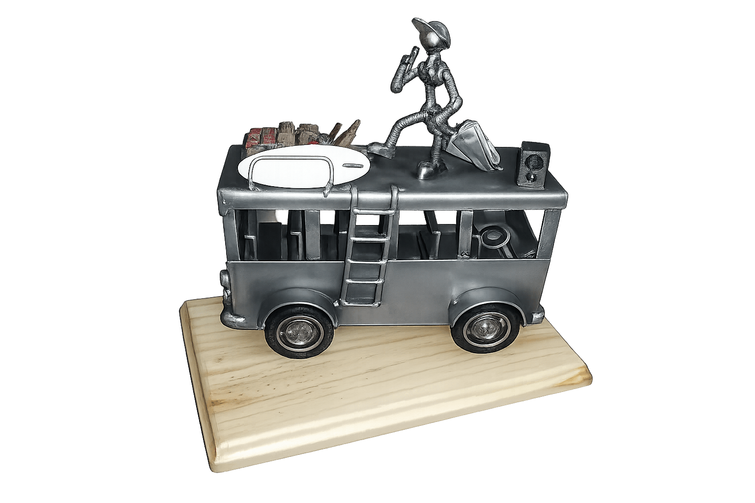 Vintage-style camper van sculpture with a figure and luggage on the roof, mounted on a wooden base